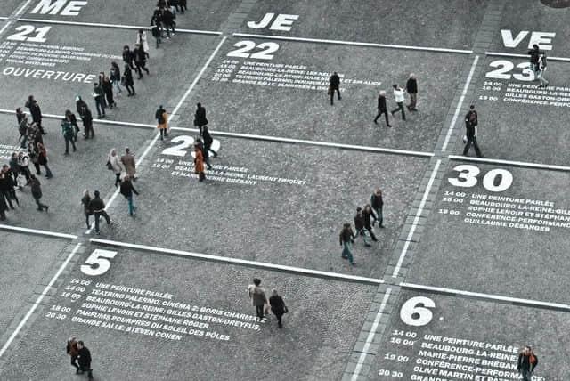 Street scene with a large calendar and people walking Street scene with a large calendar and people walking