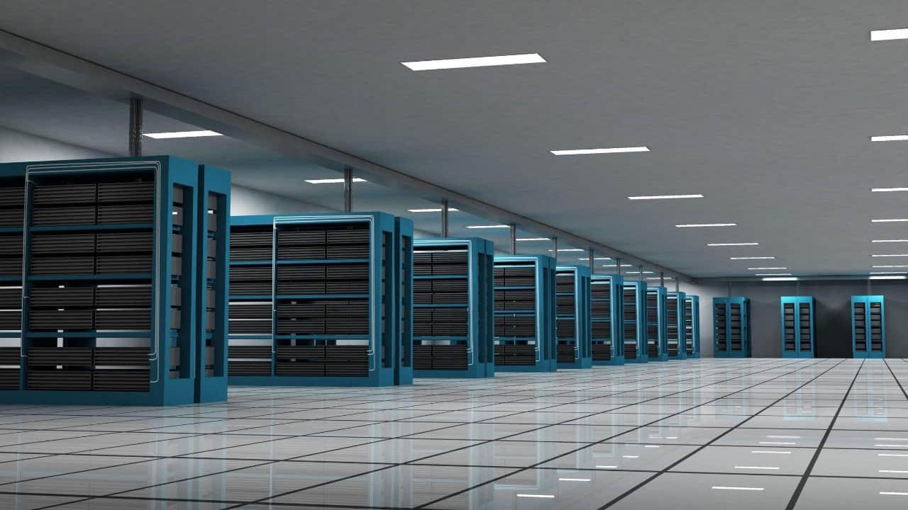 Person standing in front of a giant computer screen with numbers, data